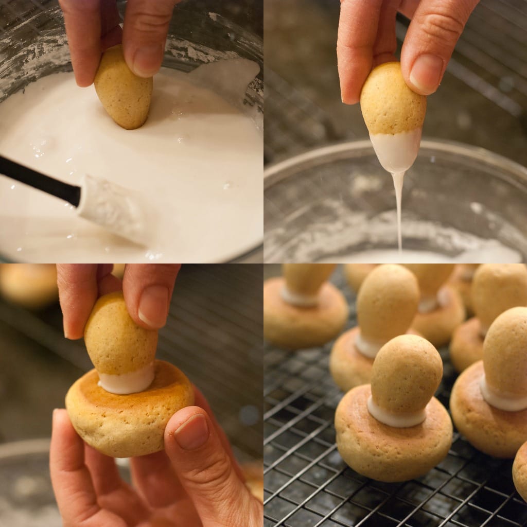 dipping mushroom cookie stems in icing then gluing to cookie caps