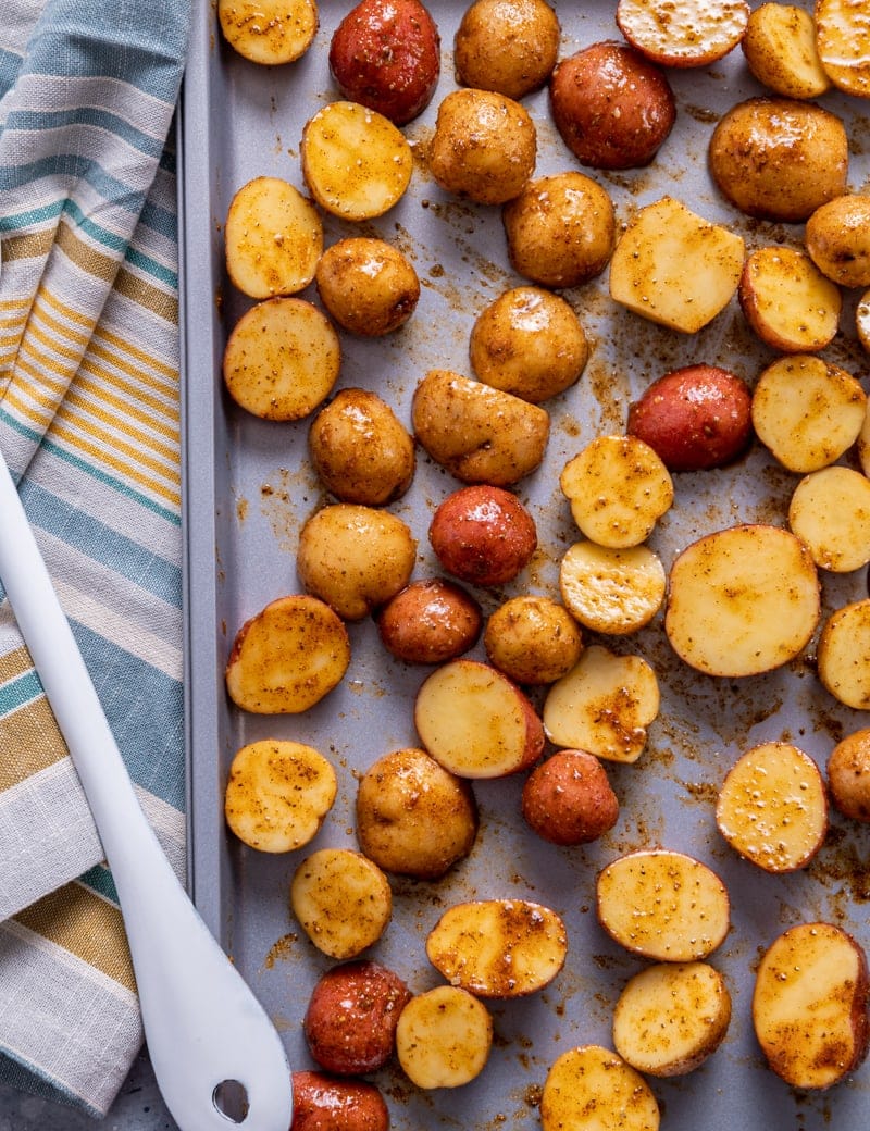 tray of roasted seasoned baby potatoes cut in half