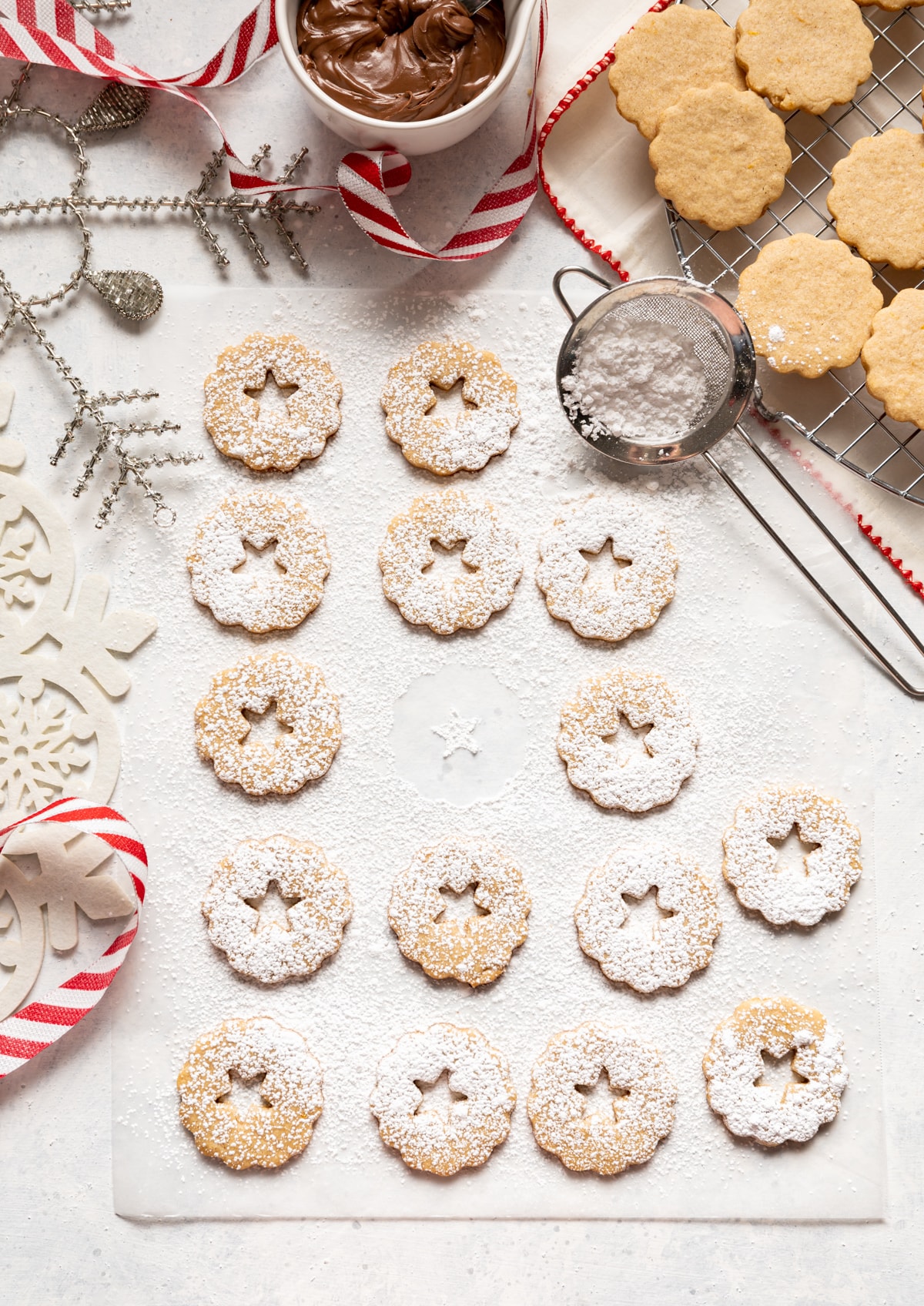 cookies with stars cut out of middle dusted with powdered sugar