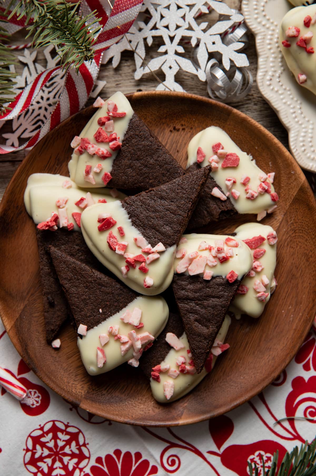 chocolate wedge shortbread cookies half dipped in white chocolate sprinkled with peppermint bits