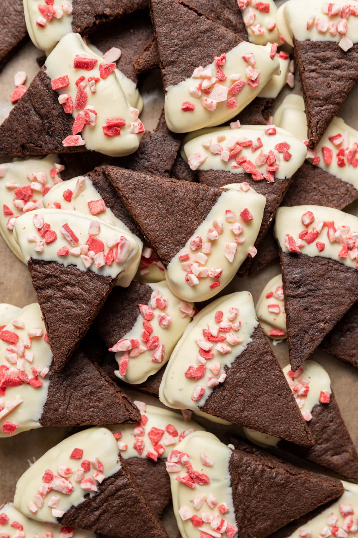 chocolate wedge shortbread cookies half dipped in white chocolate sprinkled with peppermint bits