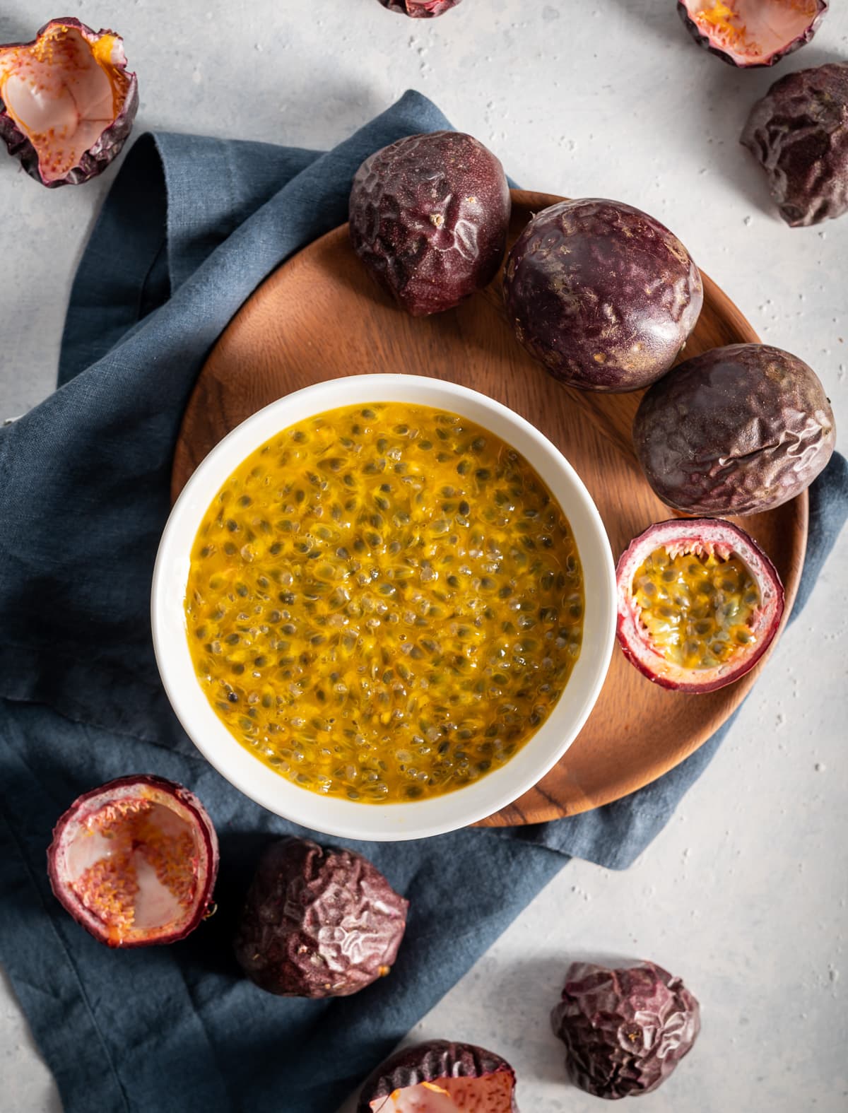 passion fruits cut in half bowl of passion fruit pulp and seeds brown plate and napkin