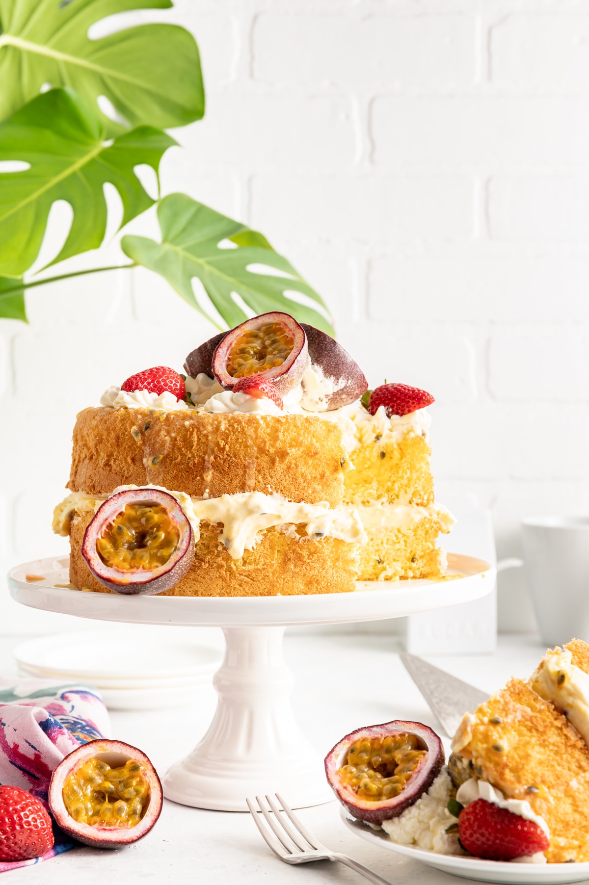 two layer passionfruit spongecake with cream strawberries and passionfruits