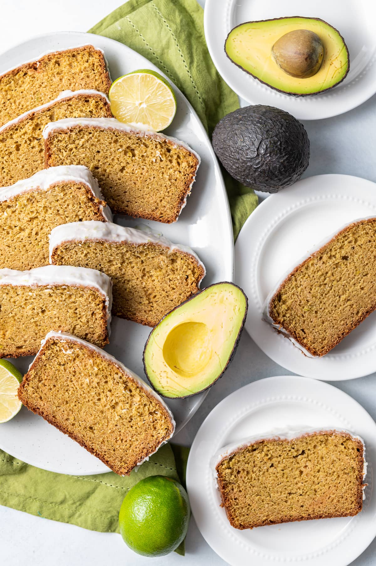 slices of avocado bread on a platter with avocados cut in half