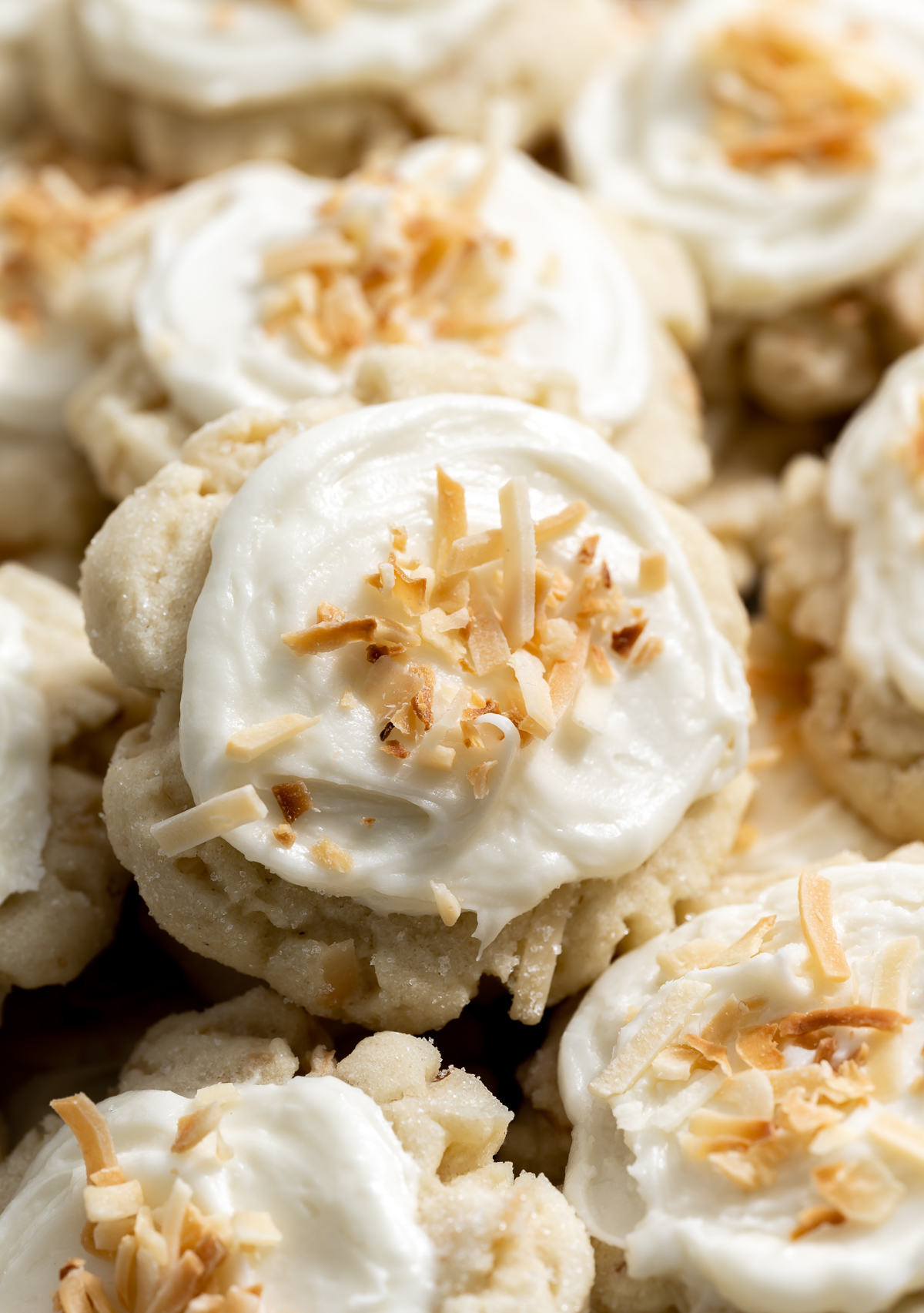 coconut cookies with coconut frosting on a white plate 