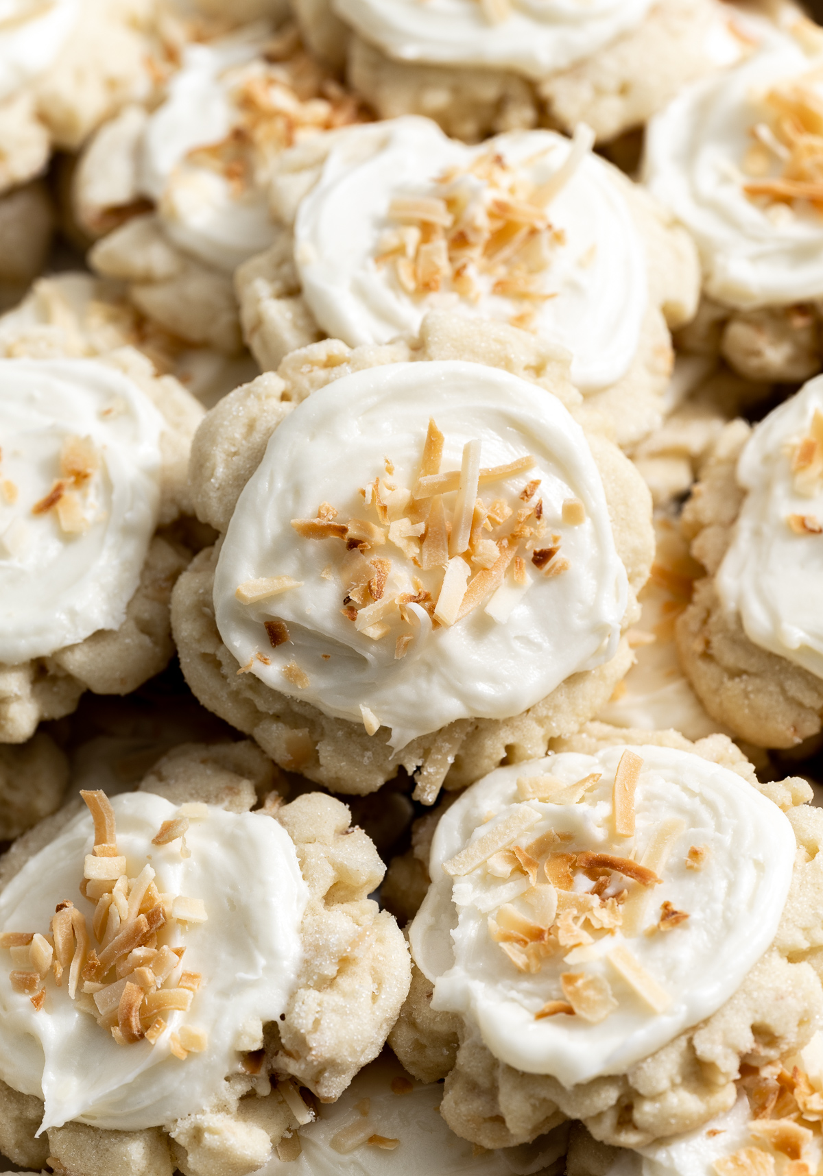 coconut cookies with coconut frosting on a white plate 