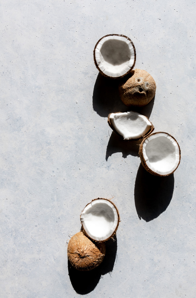 halves and pieces of fresh coconuts still in shell