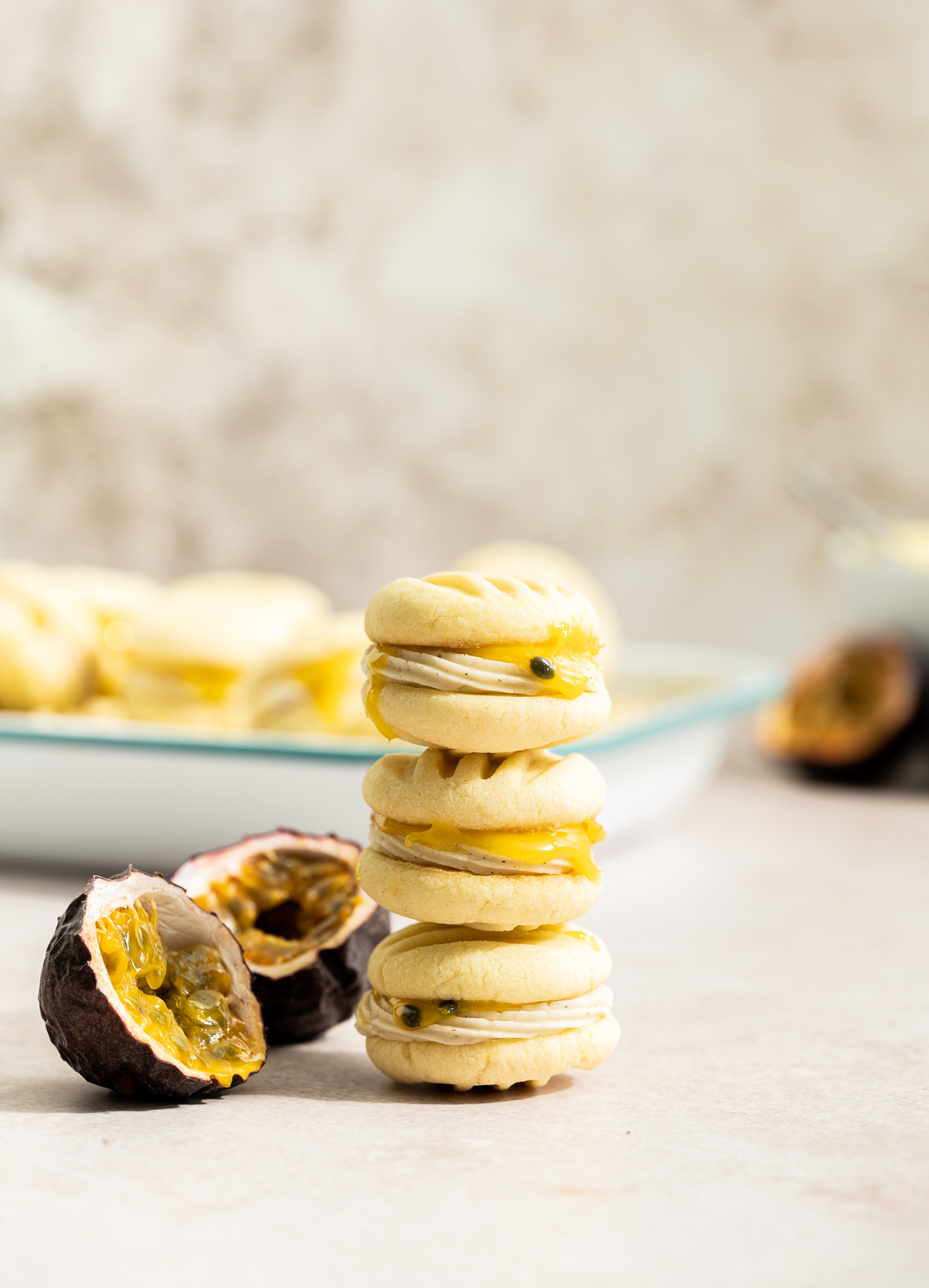 stack of passionfruit sandwich cookies passionfruit cut in half