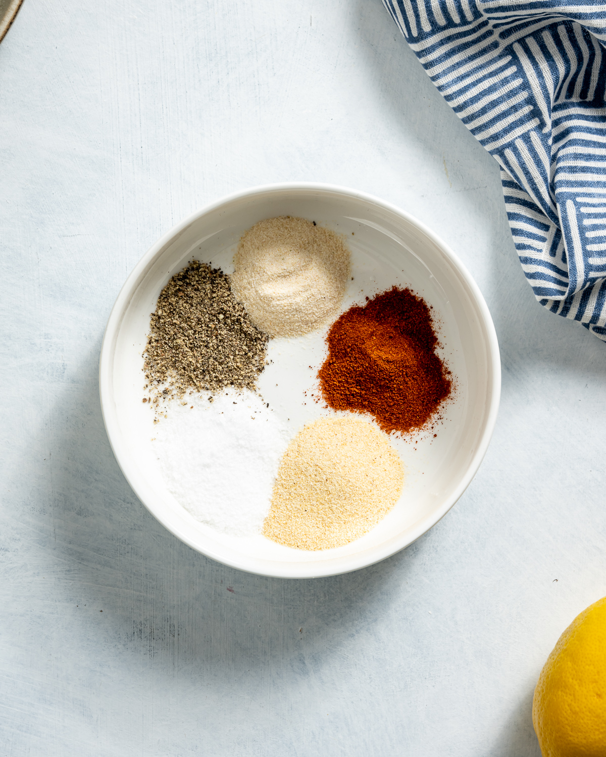 bowl of white black red and yellow spices