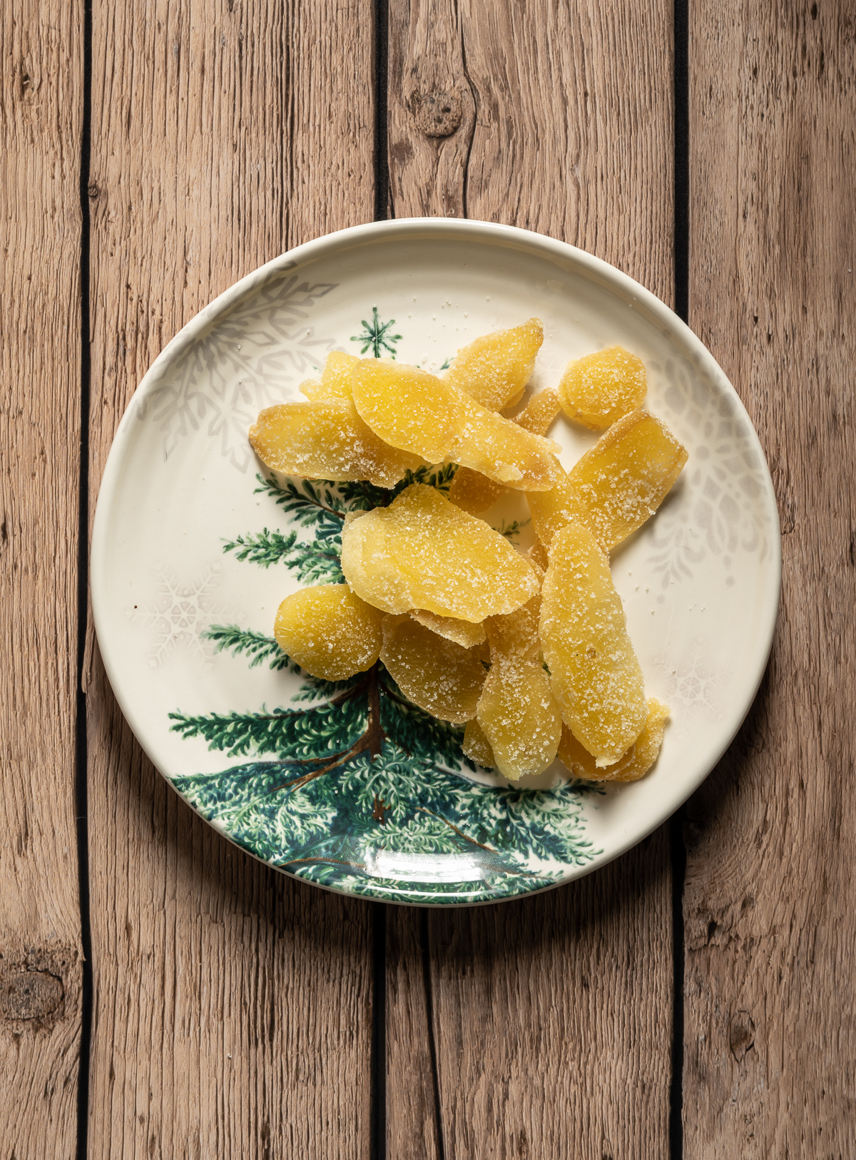 plate of crystalized ginger pieces on a plate with a green tree