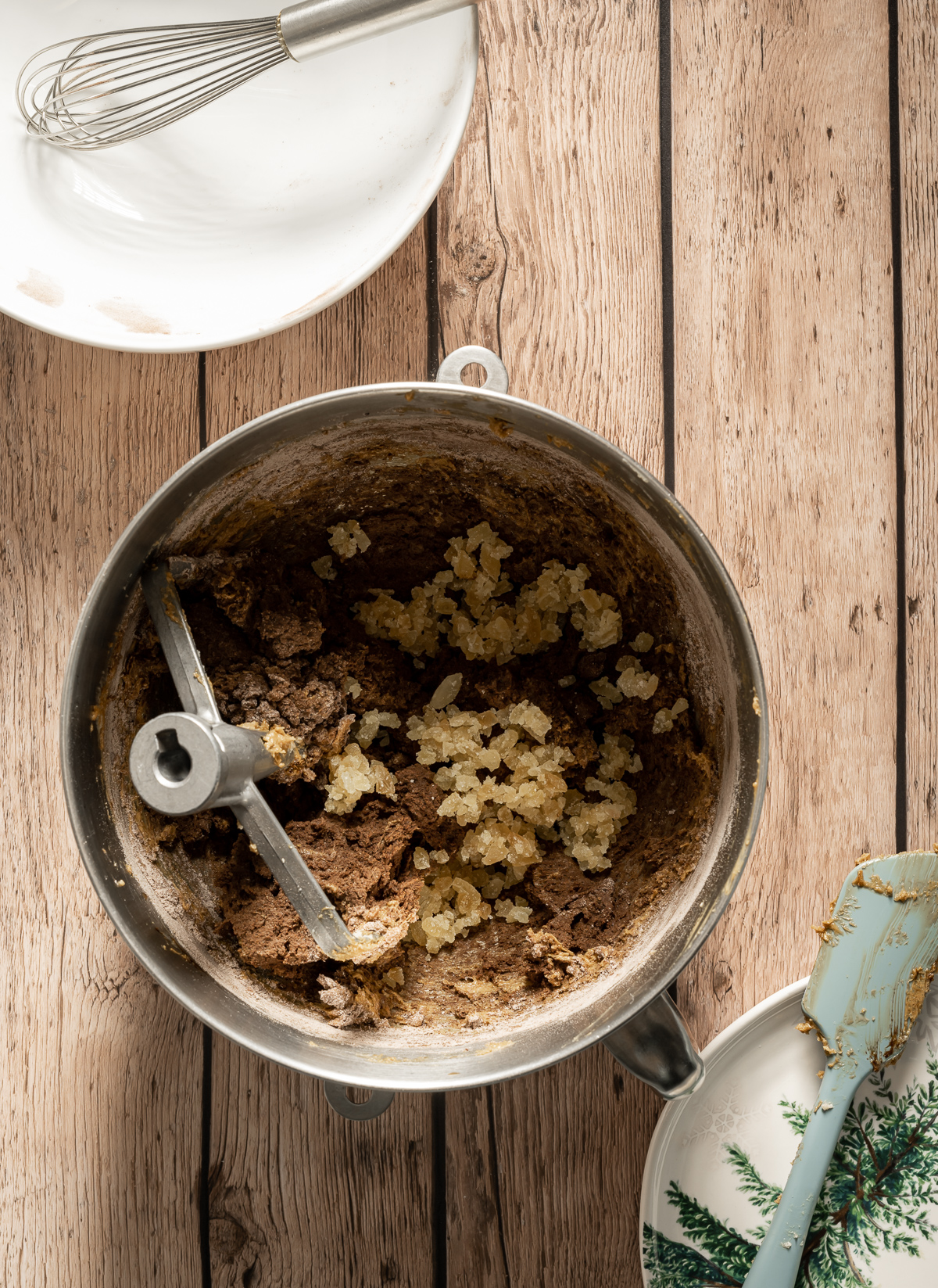 stand mixer bowl with chocolate cookie dough and crystallized ginger pieces