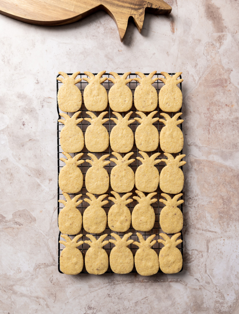 baked pineapple shaped cookies on a wire rack