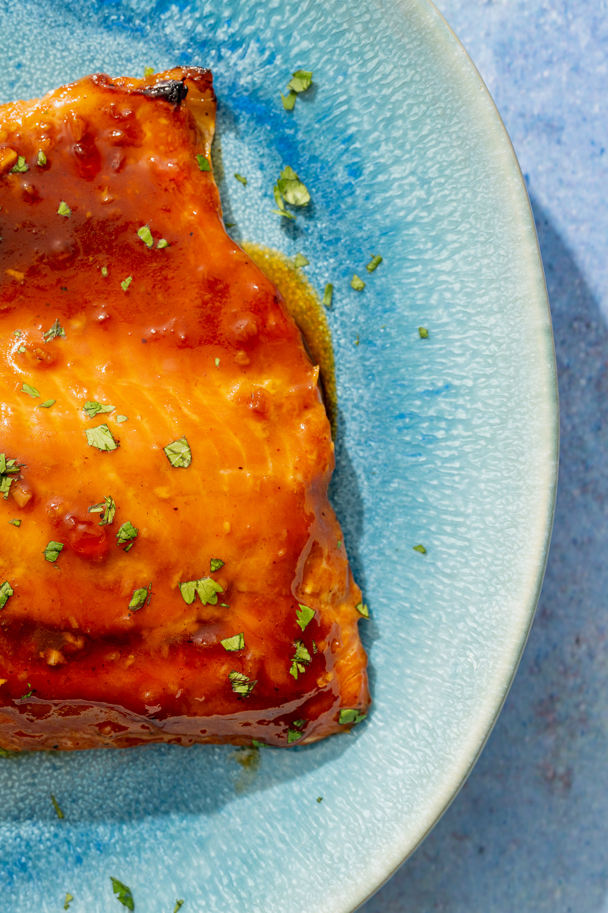 baked wild Alaskan coho salmon on a blue platter 