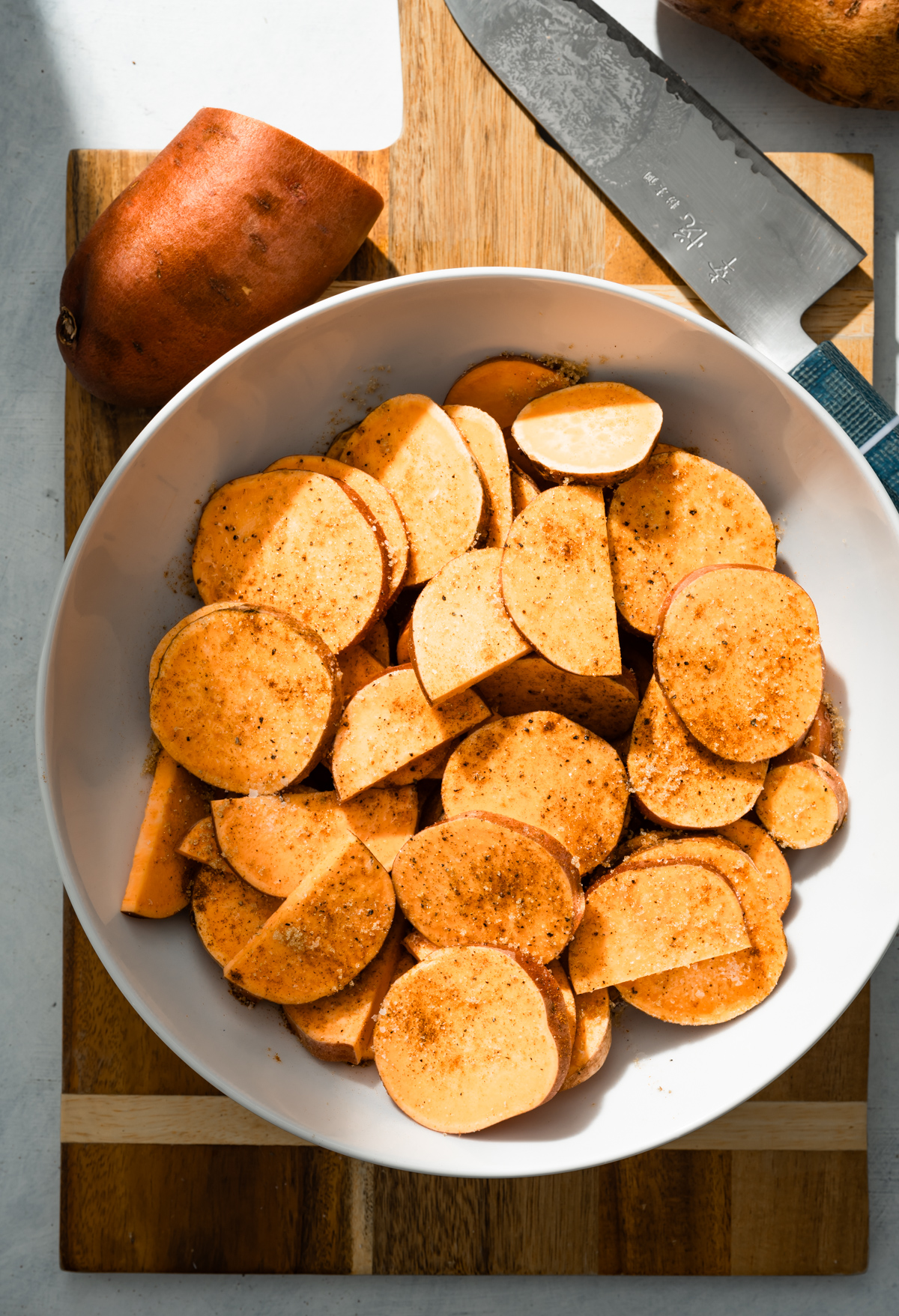 sliced seasoned sweet potatoes in a bowl