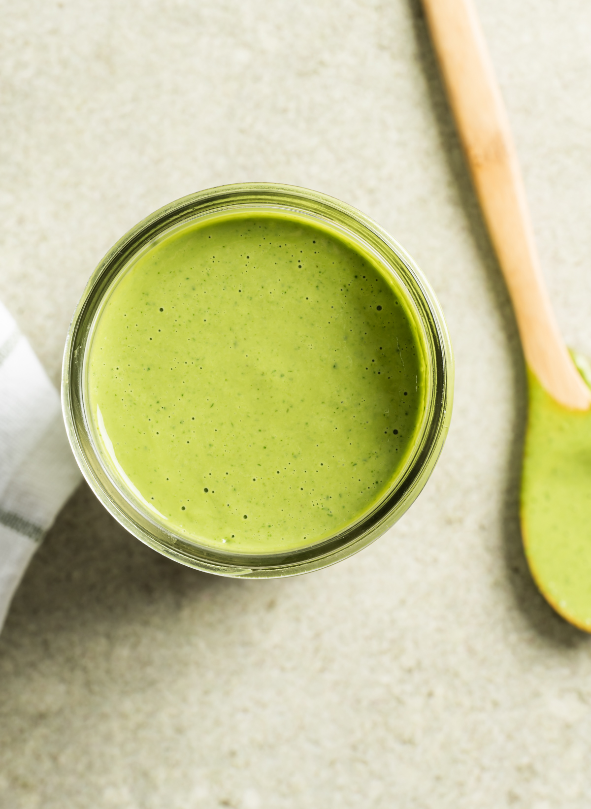 mason jar with green cilantro salad dressing