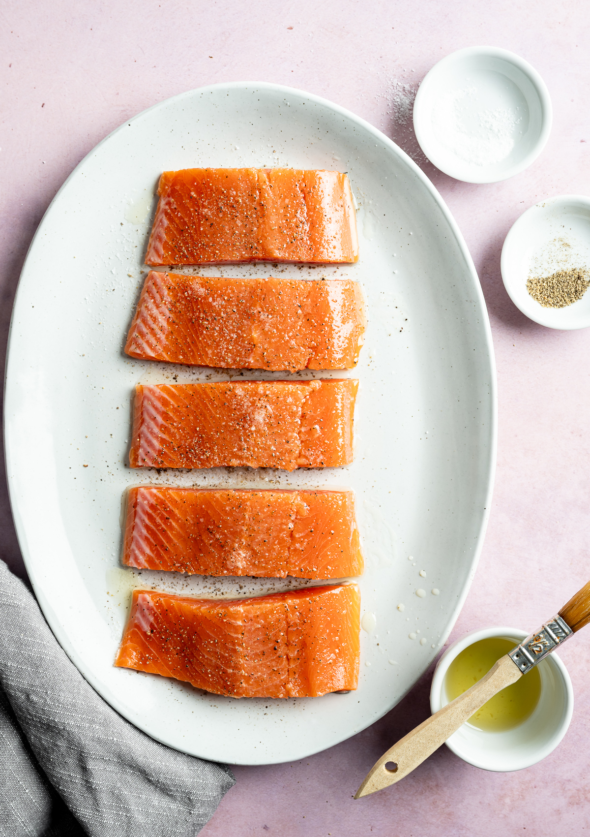 salt and pepper on salmon fillets