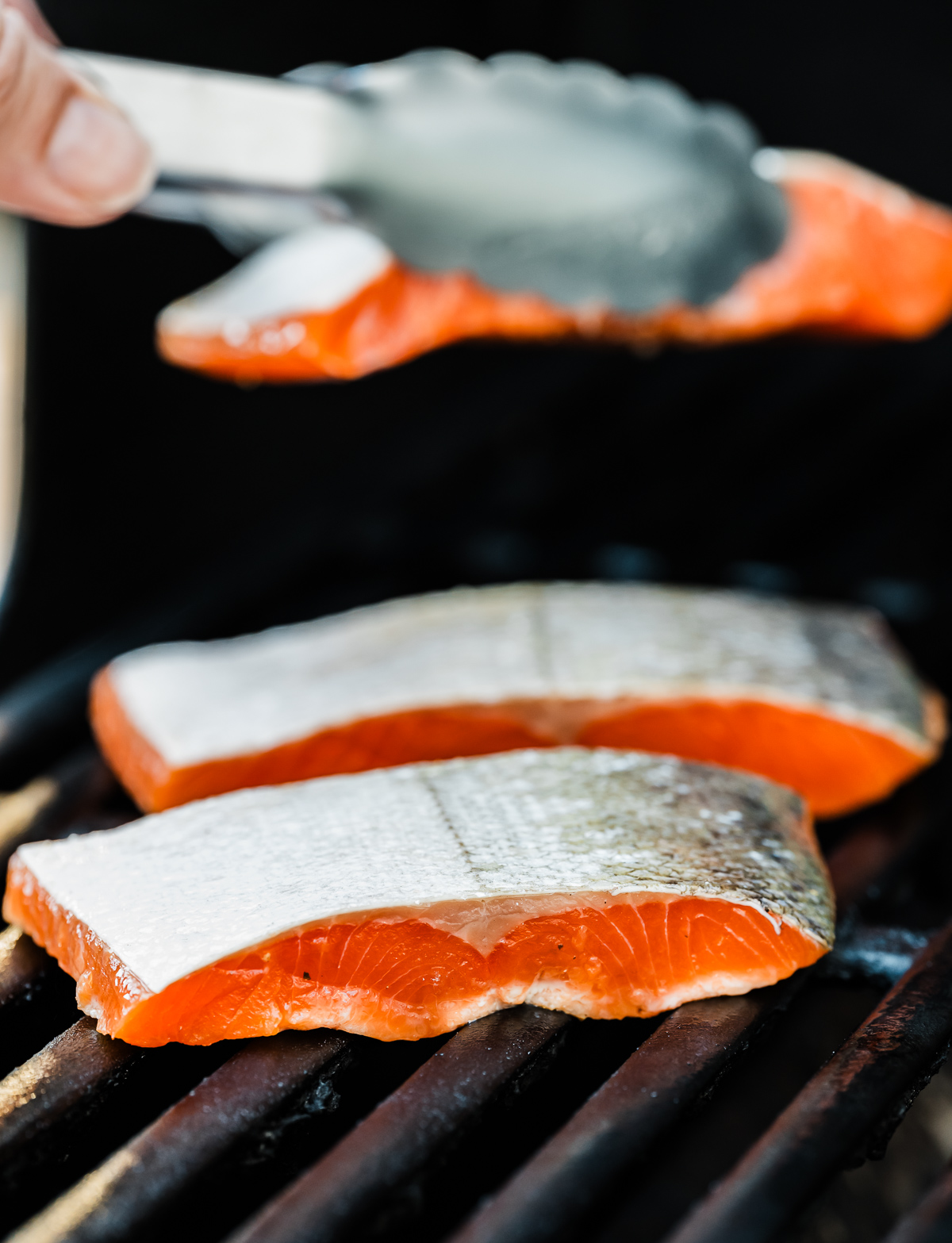 salmon fillets on grill with skin side up