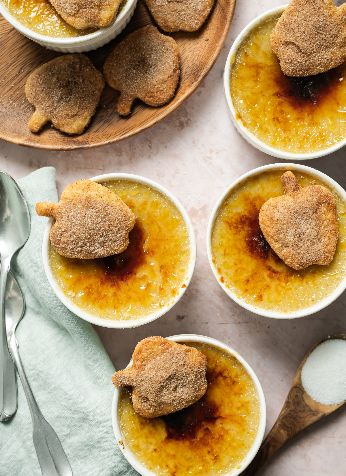 apple pie crème Brûlée with spiced apple shaped pie crust cookies wood plate spoons