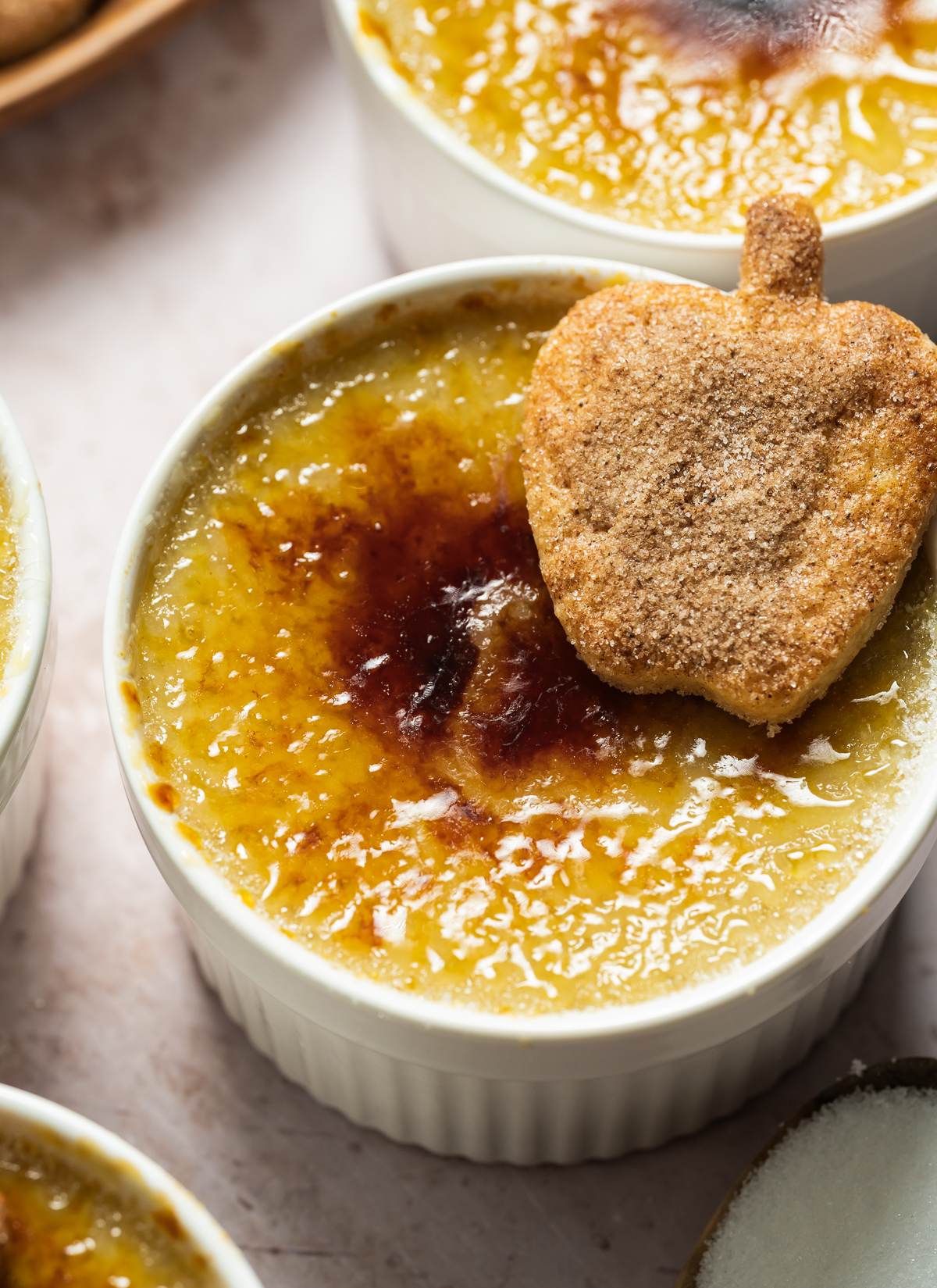 apple pie crème Brûlée with spiced apple shaped pie crust cookies wood plate spoons