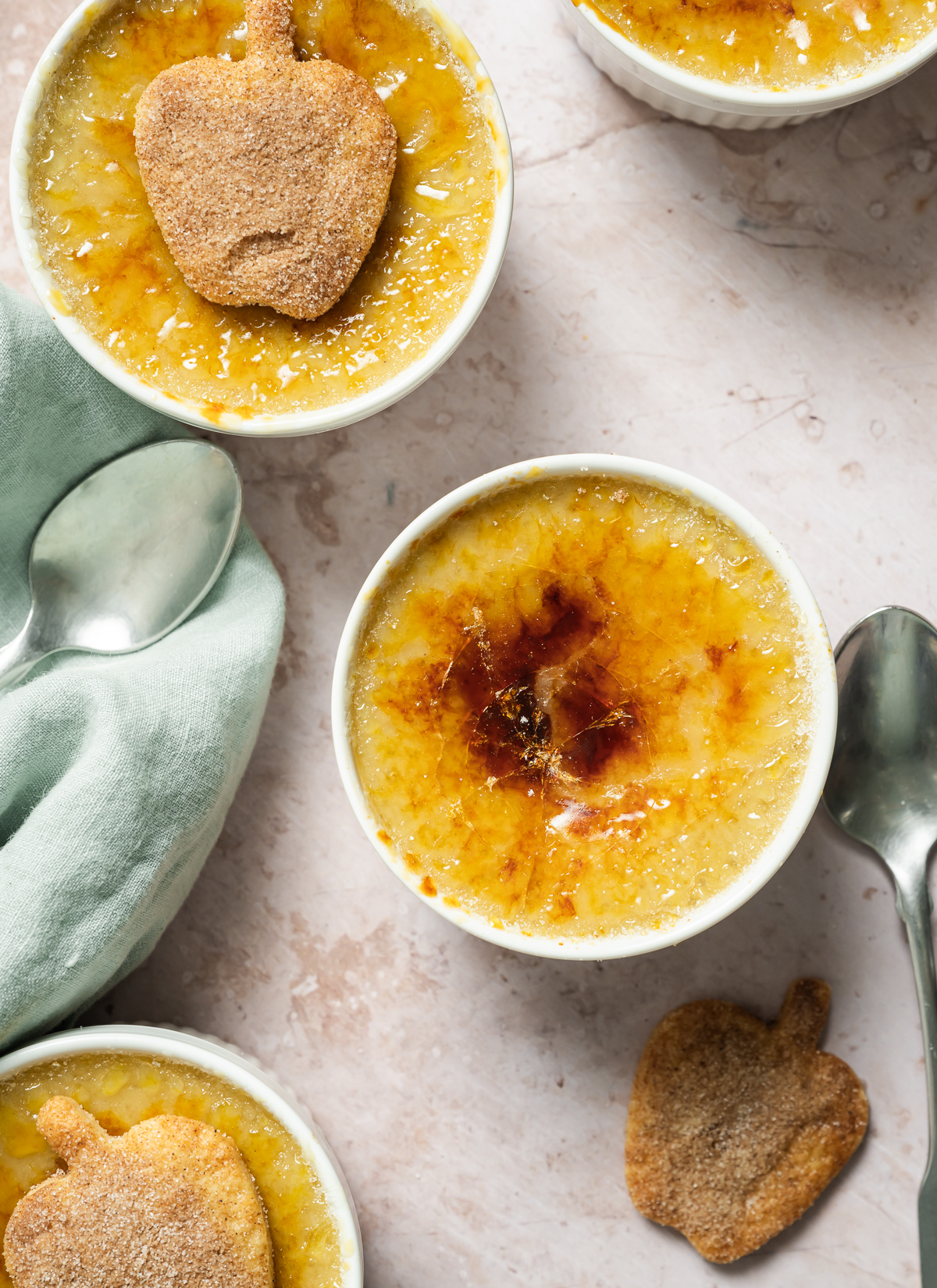 apple pie crème Brûlée with spiced apple shaped pie crust cookies wood plate spoons