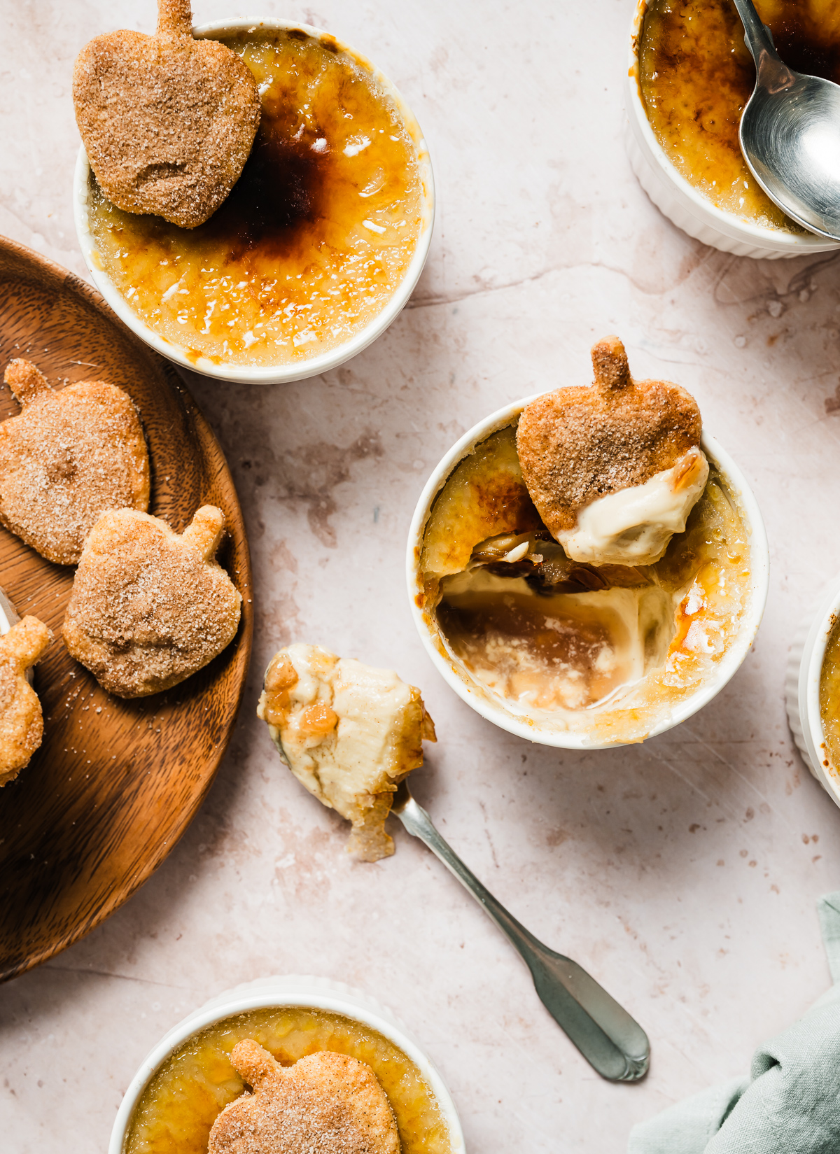 apple pie crème Brûlée with spiced apple shaped pie crust cookies wood plate spoons