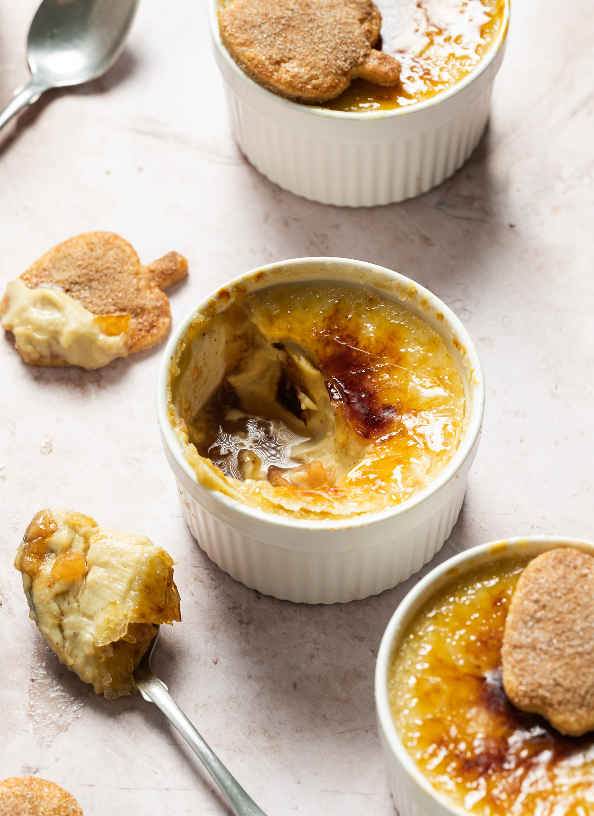 apple pie crème Brûlée with spiced apple shaped pie crust cookies wood plate spoons