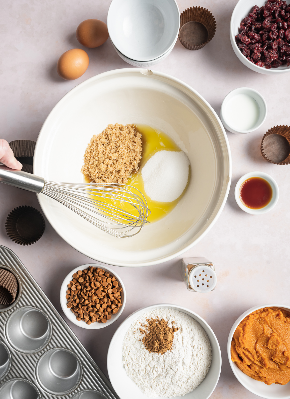 melted butter and sugars in a bowl, various bowls of separate muffin ingredients