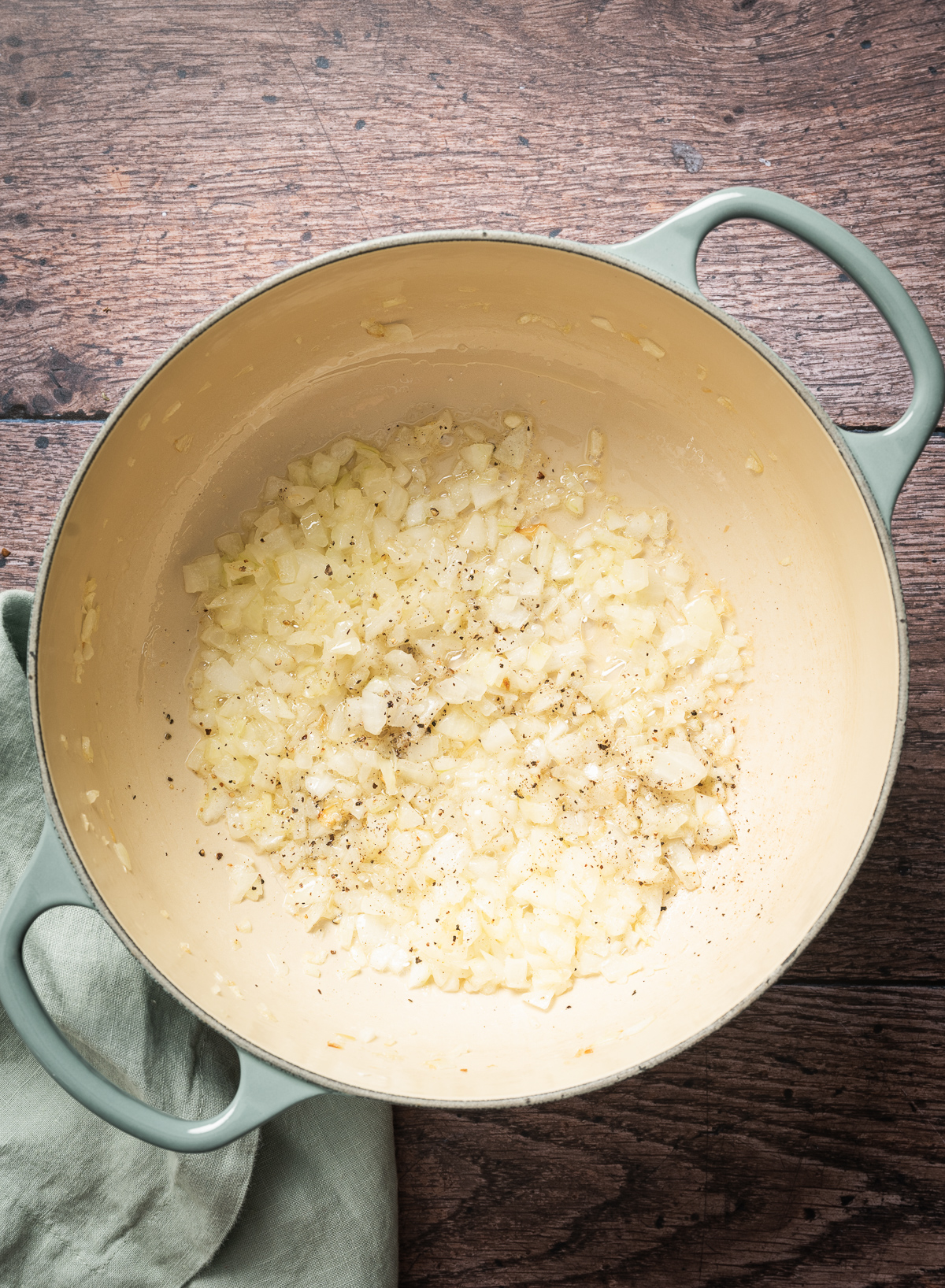 chopped onion in large pan with salt and pepper