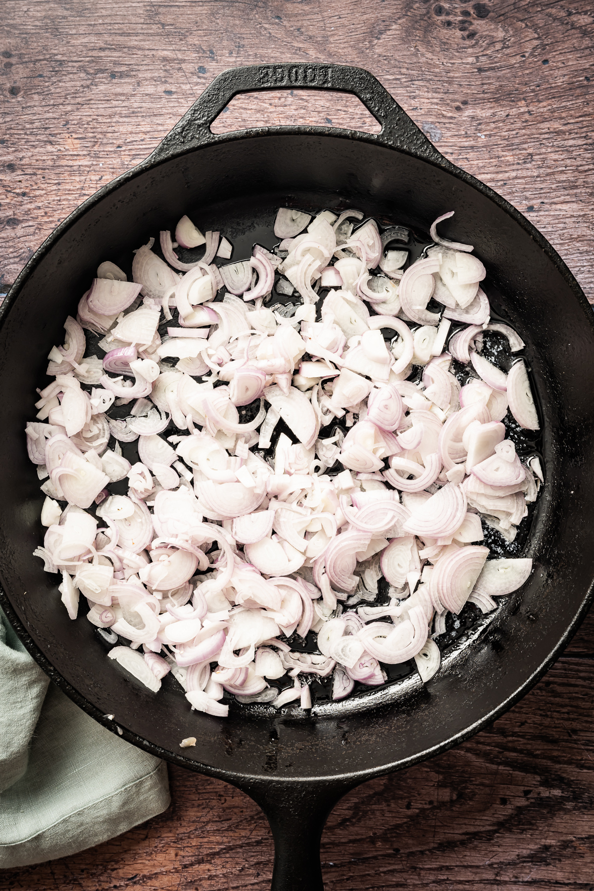 sliced shallots in cast iron pan