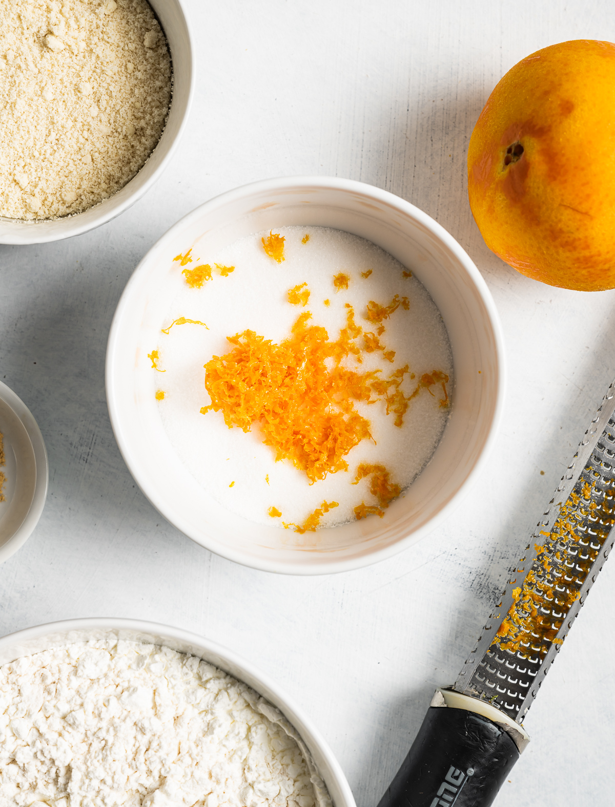 Orange zest in a bowl of sugar