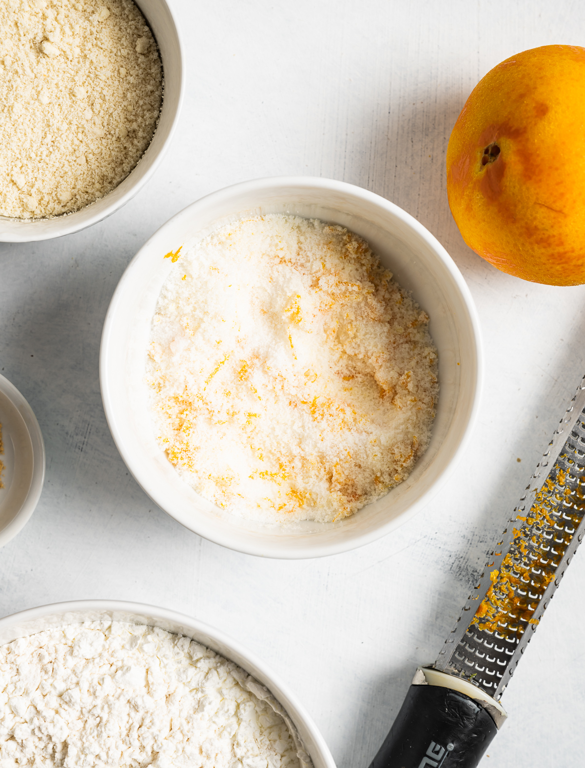 orange zest mixed in a bowl of sugar