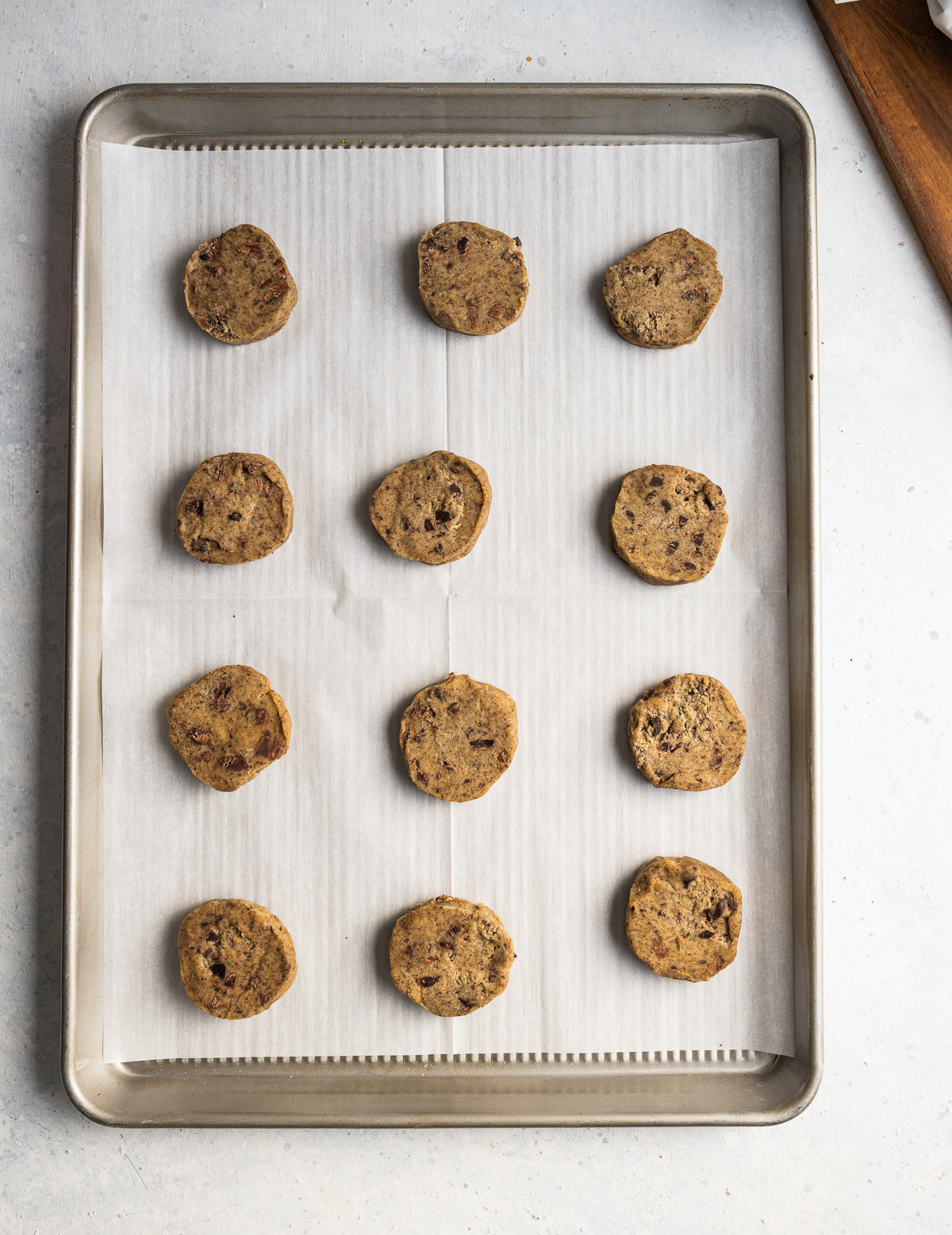 raw shortbread cookie dough on a baking sheet with parchment paper