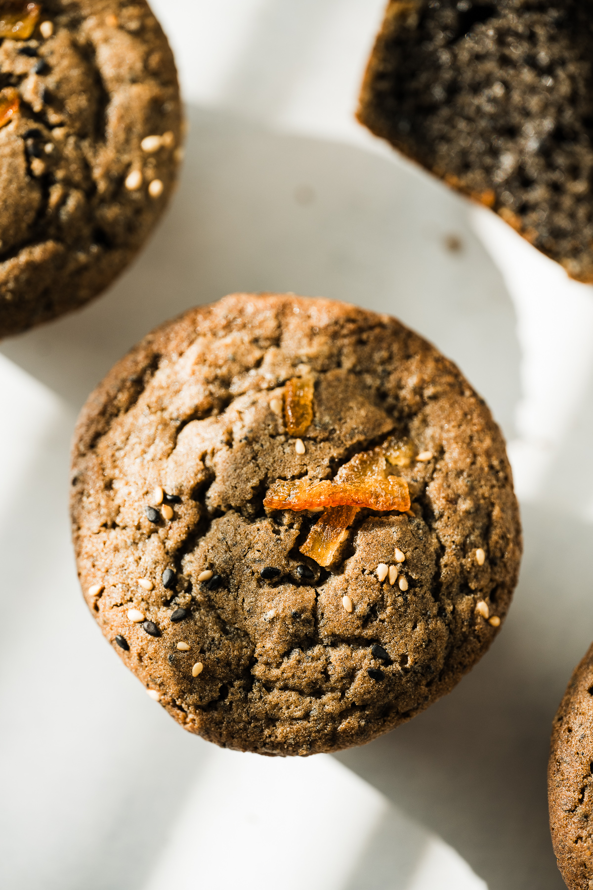 brown mochi muffin with sesame seeds and yuzu peel