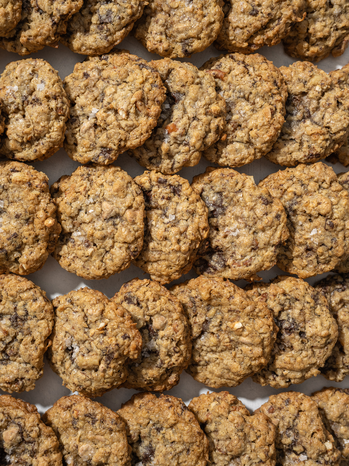 everything oatmeal cookies with flake salt scattered around a table